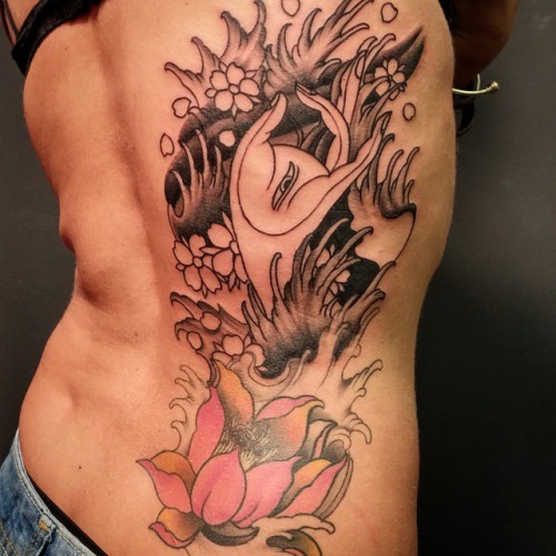 lotus-flower-tattoo-lower-back-e1449058584942