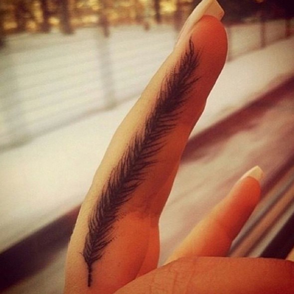 small-feather-tattoo-on-finger