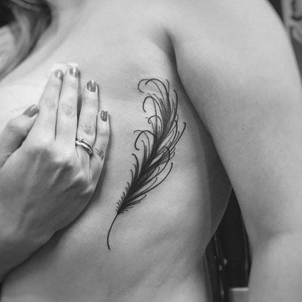small-feather-tattoo-on-side