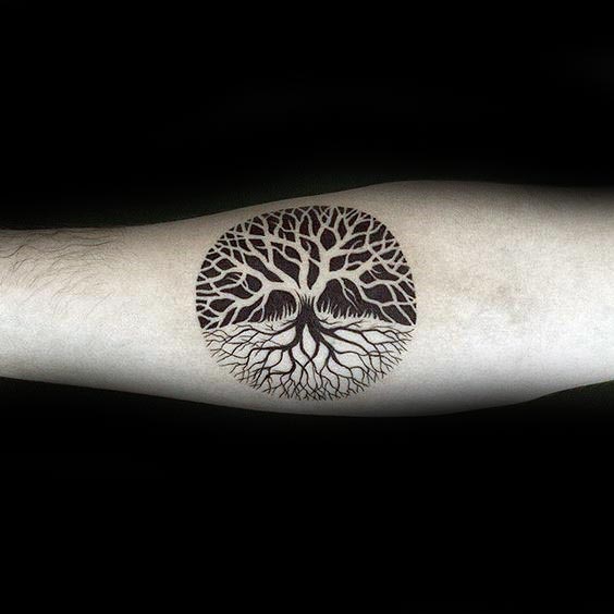 negative-space-guys-small-circle-tree-of-life-tattoo-design-on-inenr-forearm
